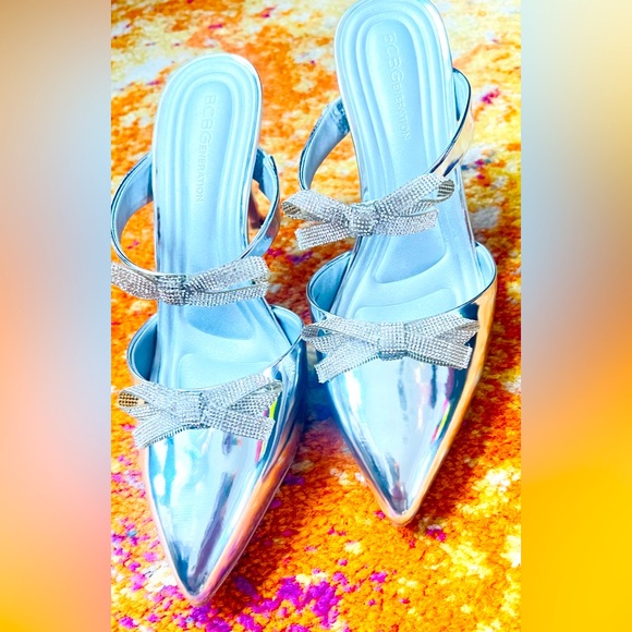 New BCBGeneration
Bardia Metallic Patent Rhinestone Bows Dress Mules - Picture 9 of 13